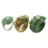 Collection of Three Jade Rings. Including one carved jadeite ring depicting a mythical beast, size 7