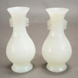 A Pair of Large White Glass Vases Both carved with archaistic designs and with handles flanking