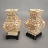 A Pair of Carved Bone and Enamel Vases Featuring dragons, with wood stands.
