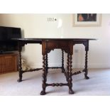 A Waring & Gillow reproduction oval walnut gate leg table on Braganza scroll feet, Width 19”