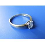 A diamond solitaire ring , the brilliant cut stone weighing approximately .60 carat (chipped