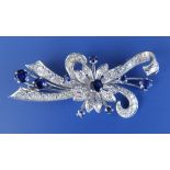 A sapphire & diamond floral spray brooch, set in white metal, 2” across