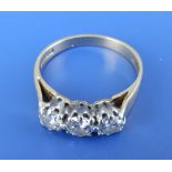 A three stone diamond ring, the claw set brilliant cut stones of total weight approximately one