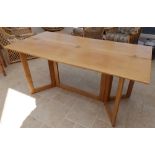 A Conran design folding rectangular dining table, on gate leg supports, Width 63”