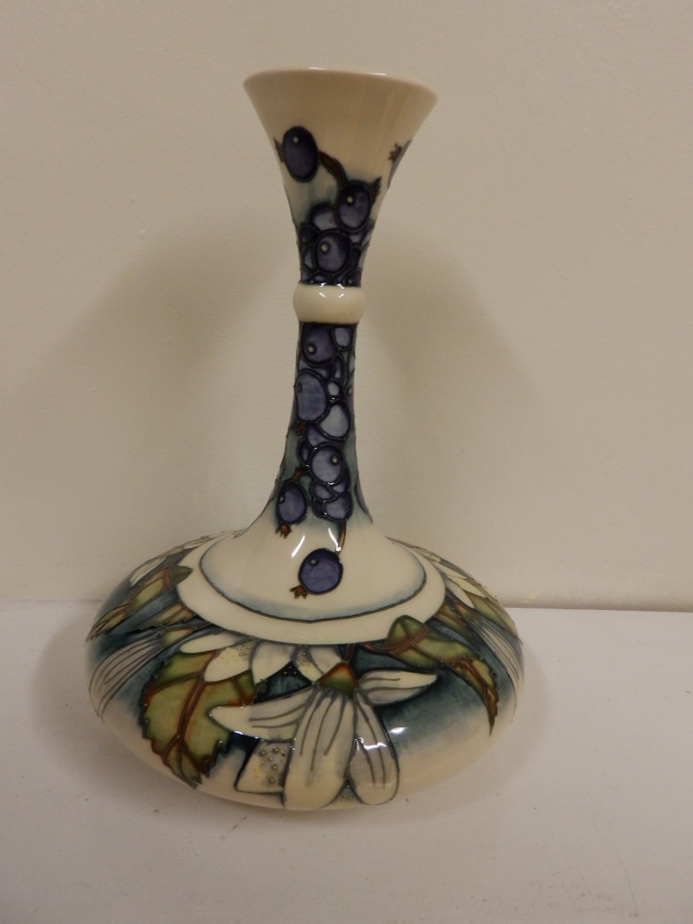 A boxed Moorcroft Juneberry pattern vase