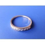 A small diamond set 18ct gold half eternity ring