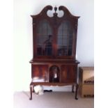 A reproduction American 18thC style two-stage bookcase, the base with arched recess, Height 87”,