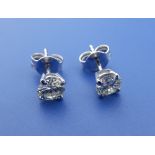 A pair of diamond stud earrings, each brilliant cut stone weighing approximately .50 carats, four-