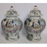 A pair of 19thC Chinese porcelain covered vases, of inverted baluster shape, painted in famille rose