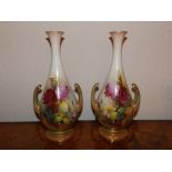 A pair of two-handled Royal Worcester vases painted roses by R. Austin, 11.5” high