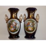 A large pair of 19thC continental porcelain two-handled vases, each decorated with an oval panel