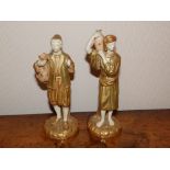 A pair of Royal Worcester figures – Arab water carriers in blush ivory & gilt, 8” high – one water