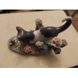 A boxed Lladro cat with flowers