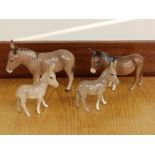 Four small Beswick donkeys