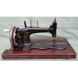 A vintage sewing machine, the iron base of fiddle shape