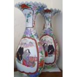 A large pair of Japanese porcelain vases decorated figures – one repaired, 22” high