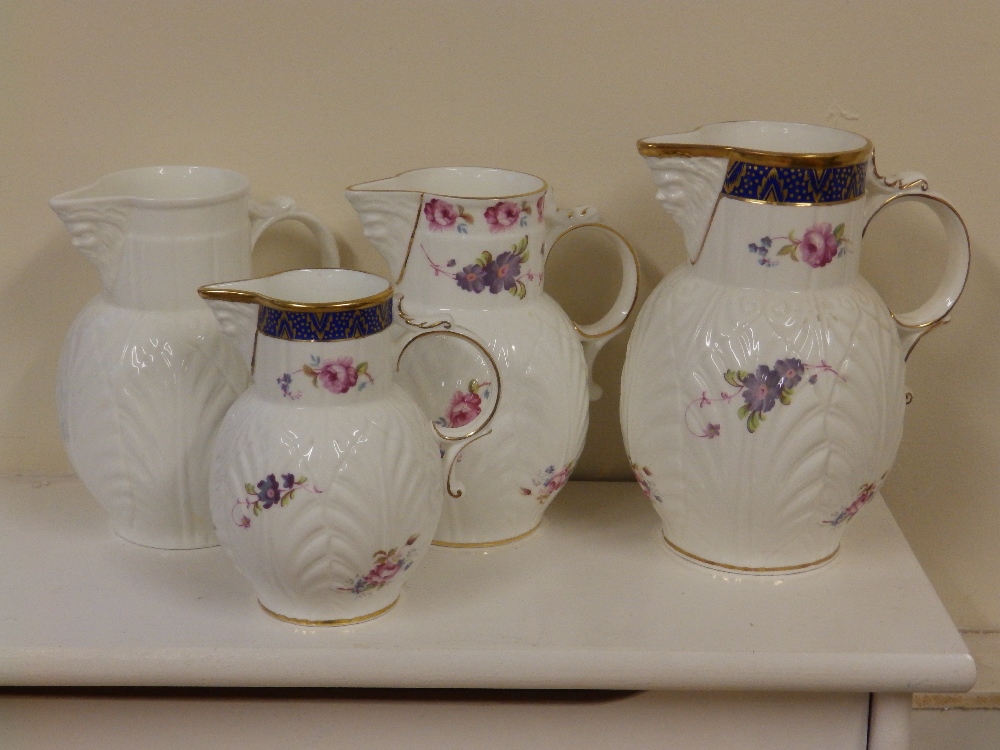 Four modern Coalport jugs in Caughley mask pattern