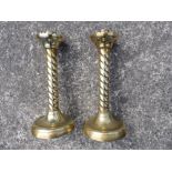 A pair of Victorian wrythen moulded brass candlesticks