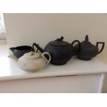 A Wedgwood black basaltes teapot & cream jug, one other basaltes teapot and a Wedgwood creamware
