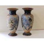 A pair of Doulton Lambeth stoneware vases with foliate decoration