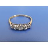 A graduated five stone diamond ring, the central old cut stone weighing approximately 0.30 carat.