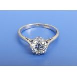 A diamond solitaire ring, the claw set brilliant stone weighing approximately 1 carat.