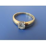 A diamond solitaire ring, the claw set brilliant weighing approximately 0.60 carat (chipped beside