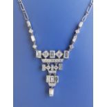 A diamond set platinum pendant necklace, having numerous millegrain mounted rectangular and round