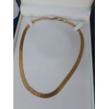 A modern 9ct gold choker strap necklace.