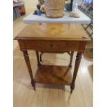 A German inlaid walnut work table on fluted round tapering legs.