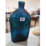 A large moulded blue glass bottle – 'Made In Italy' – neck broken