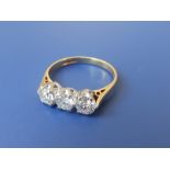 A three stone diamond ring, the claw set brilliant cut stones of total weight approximately 1 carat,