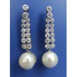 A pair of pearl & diamond drop earrings in white metal, the pearls of approximate diameter 11mm.