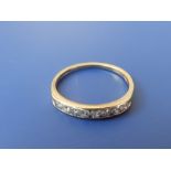 A small diamond set 18ct gold half eternity ring.