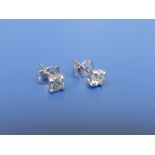 A pair of diamond solitaire stud earrings , each brilliant weighing approximately 0.25 carat in .750