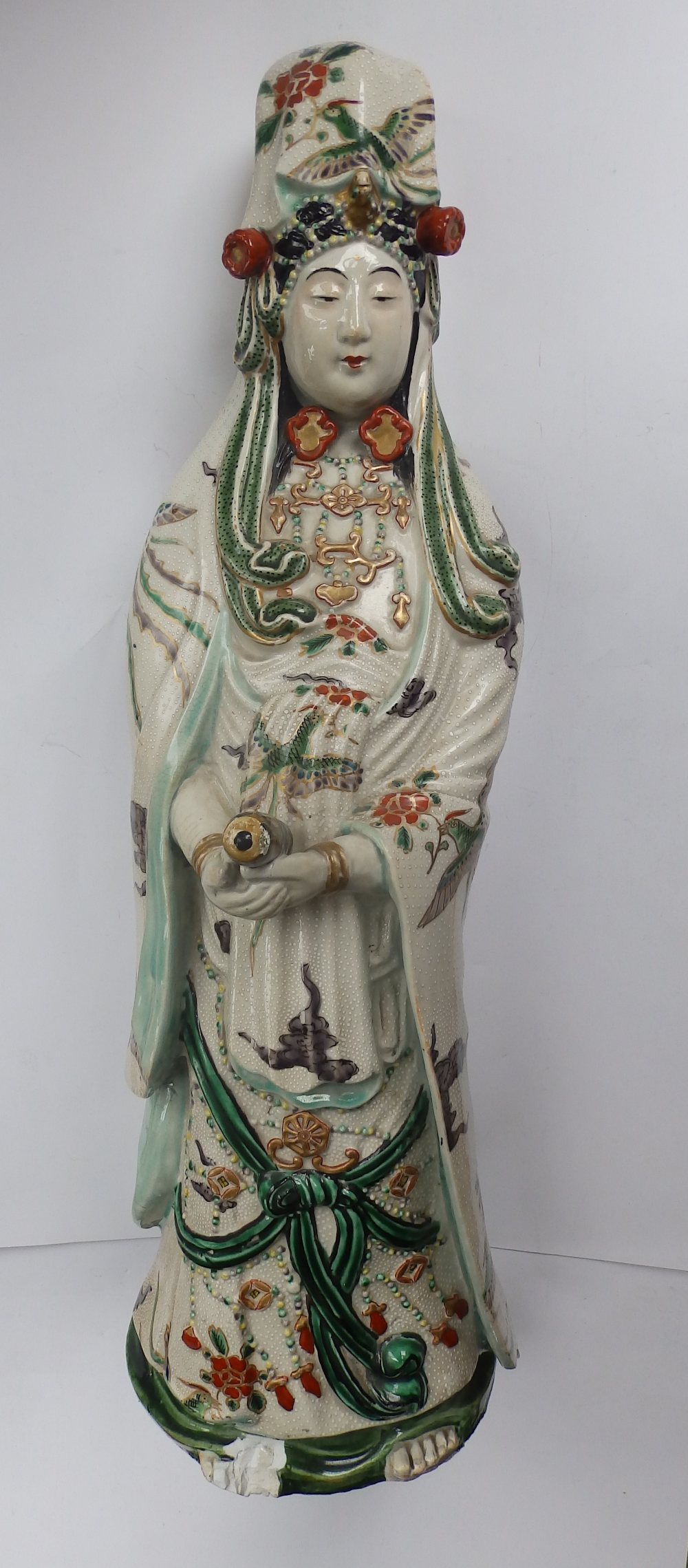 A Chinese porcelain figure of Kuan Yin, decorated in famille verte palette, 19” high – a/f