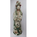 A Chinese porcelain figure of Kuan Yin, decorated in famille verte palette, 19” high – a/f