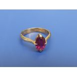 A modern ruby solitaire ring, the oval cut stone weighing approximately 2 carats, four claw set in