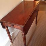 A William IV mahogany pembroke table, with frieze drawer on reeded legs to brass castors, 15.5”