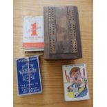 A folding cribbage board, old Belgian playing cards, Snap and two other packs.