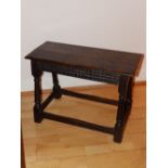 An antique style oak double stool, on turned splayed legs united by low stretchers, Width 27” -