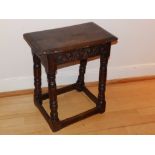 A 17thC oak joint stool, having lunette carved frieze between four turned splayed legs, Height 20.