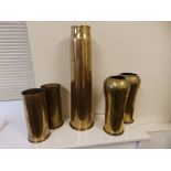 A pair of German trench art shell case vases and three other shell cases. (5)