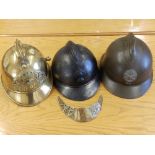 A vintage French brass fireman's helmet, two French Adrian helmet and a WWI Adrian helmet 'Veteran's