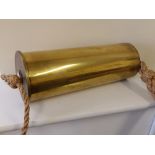 A 105mm shell case made into a door bell with bell rope and hanging line.