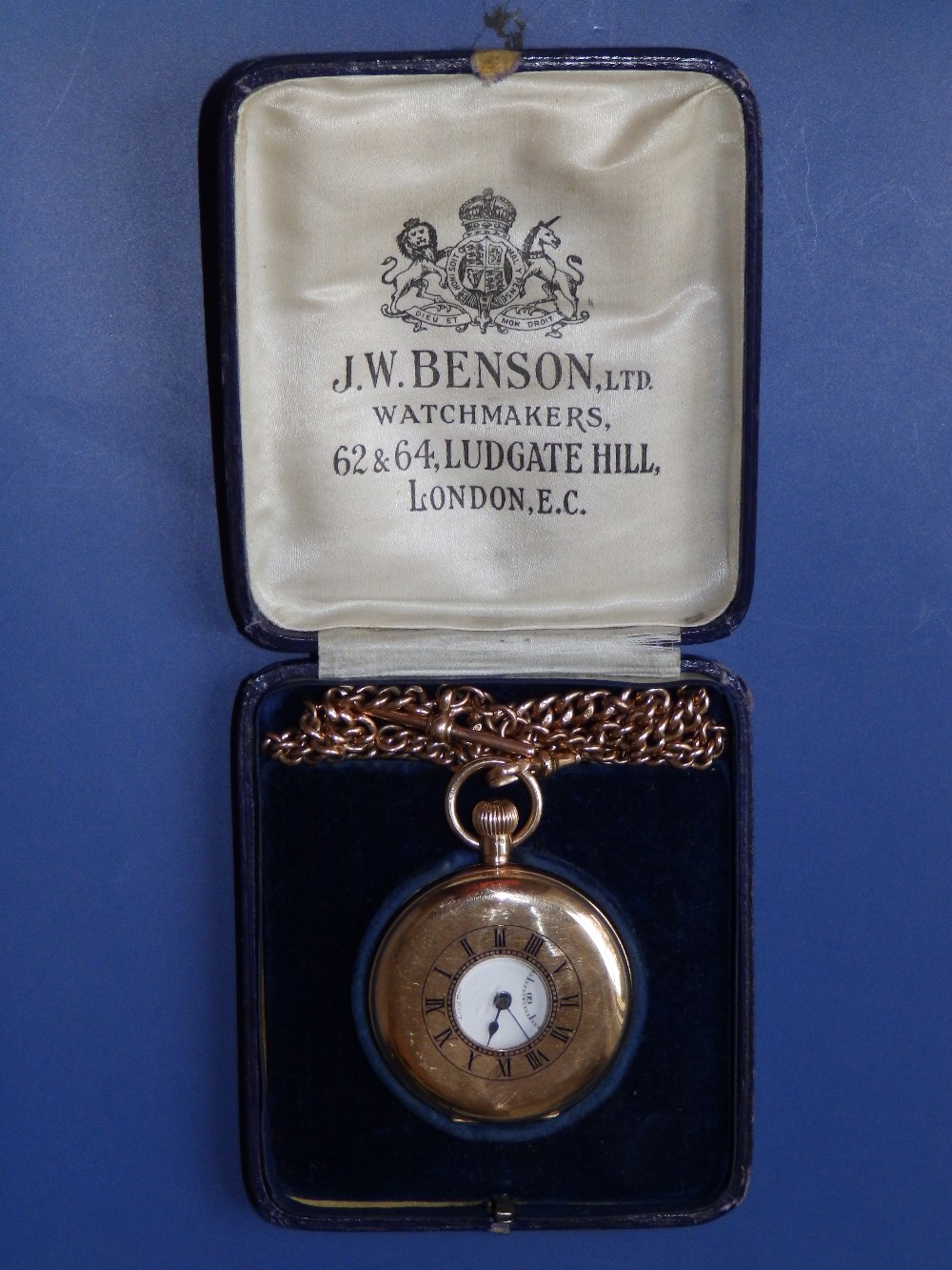 A cased 9ct gold half hunter Benson pocket watch with 14” chain, the white enamel dial with