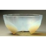 A Sabino opalescent glass bowl, with shell feet, impressed mark "Sabino, France".  Diameter 18 cm.
