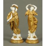 A pair of Capodimonte gilt and white draped figures, in the classical style.  Height 24 cm.