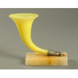 A Victorian yellow glass cornucopia, with hand and marble plinth base. Height 17 cm.