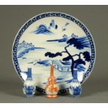 A late 19th century Chinese blue and white charger, painted with mountains, buildings and trees,